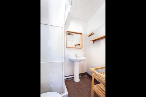 a bathroom with a sink and a toilet and a mirror at Au cœur du Panier avec terrasse 2 à 4 personnes climatisation in Marseille