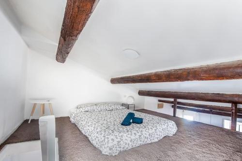 a bedroom with a bed with blue shoes on it at Au cœur du Panier avec terrasse 2 à 4 personnes climatisation in Marseille