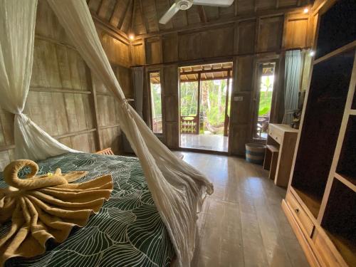 ein Schlafzimmer mit einem Bett mit einem Netz in der Unterkunft Wooden House and Spa Ubud in Ubud