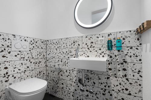 a bathroom with a toilet and a sink and a mirror at Aves Arosa in Arosa