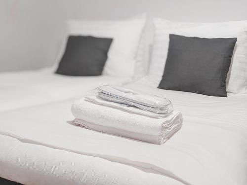 a stack of towels sitting on top of a bed at Residential Hotels Helsinki Center in Helsinki