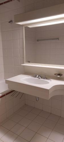 a bathroom with a sink and a mirror at Belle Époque Panorama Apartment in Bad Gastein