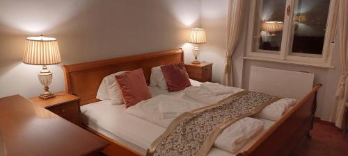 a bedroom with a large bed with two lamps at Belle Époque Panorama Apartment in Bad Gastein