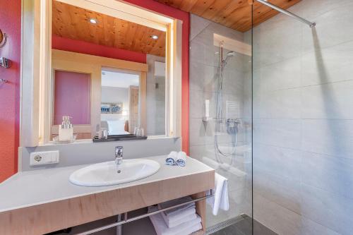 a bathroom with a sink and a shower at Gästehaus Bramböck in Bad Häring