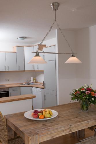 a plate of fruit on a wooden table in a kitchen at Apartments am Brandenburger Tor in Berlin