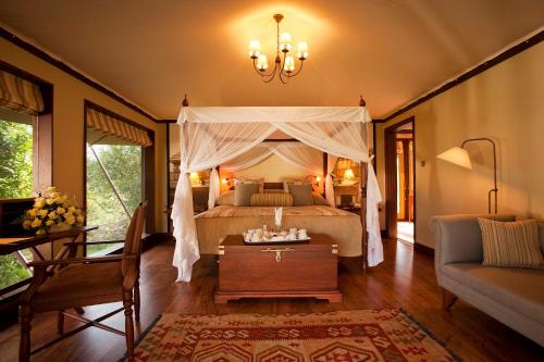 1 dormitorio con 1 cama con dosel en Lake Elmenteita Serena Camp en Elmenteita