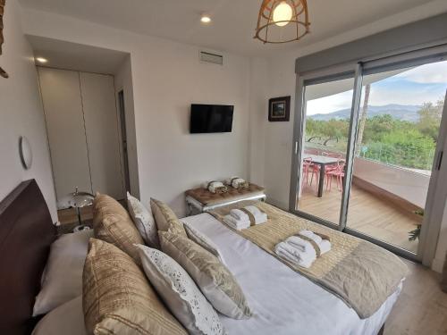 a bedroom with a large bed and a balcony at Apartment in Motril near Los Moriscos Golf in Motril