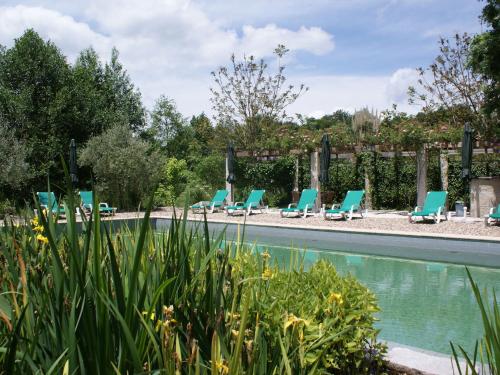 a swimming pool with lounge chairs next to a yard at Holiday Home in Covas near Serra da Estrela in Covas