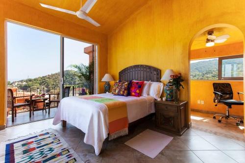a bedroom with a bed and a balcony at Orange Sunsets, Lush Landscape, Intown, Privacy in Puerto Vallarta