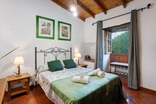 a bedroom with a bed and a large window at El Nogal in San Juan de la Rambla