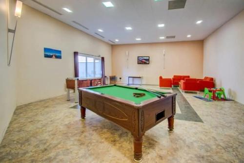 a large room with a pool table in it at Studio aux pieds des pistes, des chemins de Rando in Les Déserts