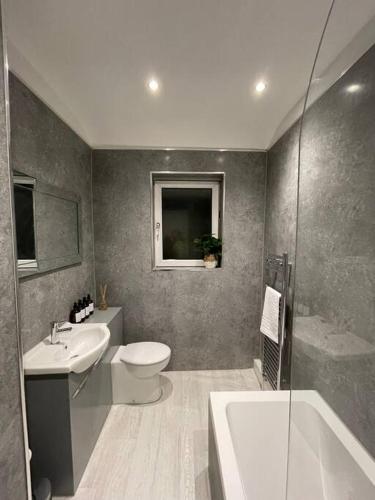 a bathroom with a sink and a toilet and a shower at Stylish 3 Bed Home in Clitheroe in Clitheroe