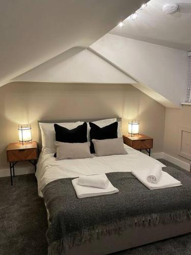 a bedroom with a large white bed with two lamps at Stylish 3 Bed Home in Clitheroe in Clitheroe