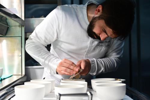 a chef is preparing food in a kitchen at Hotel Royal Paestum in Paestum