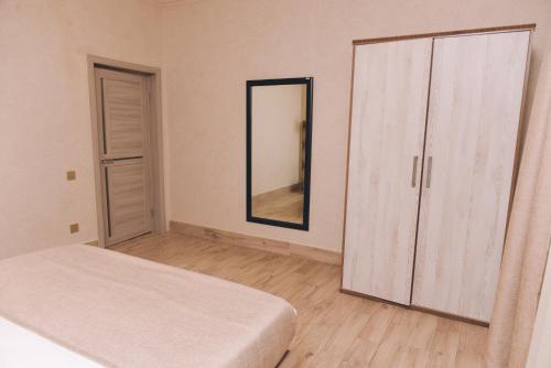 a bedroom with a bed and a large mirror at VOGUE HOTEL RESORT AND SPA - Nabran in Nabran