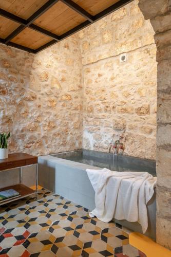 a bathroom with a bath tub and a sink at Il Quinto Elemento - Residence Of Charme in Ostuni