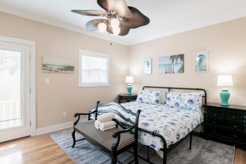 a bedroom with a bed and a ceiling fan at Island House 1Bu By Pkrm in Pensacola