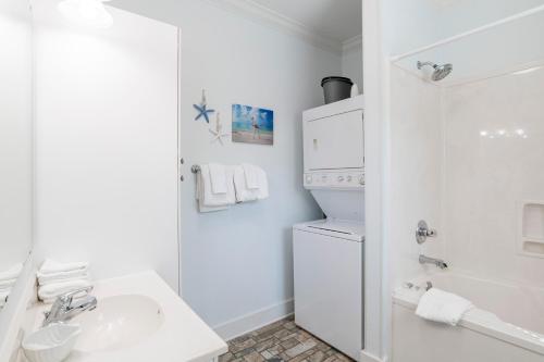 a white bathroom with a sink and a washing machine at Island House 1Bu By Pkrm in Pensacola