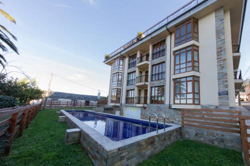 a house with a swimming pool in front of it at Apartagal-Mar de Vicedo in O Vicedo