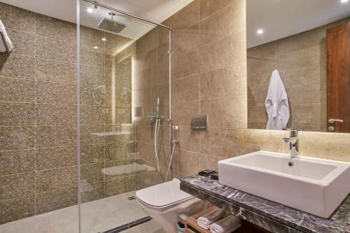 a bathroom with a toilet and a sink and a shower at Maritim Jolie Ville Resort & Casino in Sharm El Sheikh