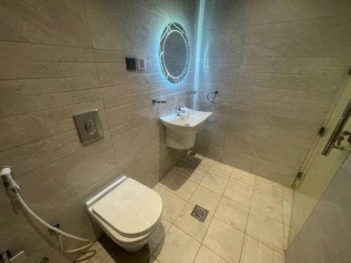 a bathroom with a toilet and a sink at Admire Apart' Hotel - Jeddah in Jeddah