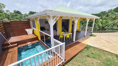 a house with a swimming pool and a gazebo at Domaine Damouw in Petit-Bourg