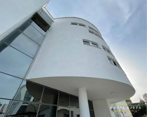a large white building with a lot of windows at HOTEL GJUTA in Tirana