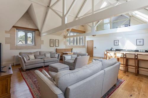 a large living room with couches and a table at The Old Library in Painswick