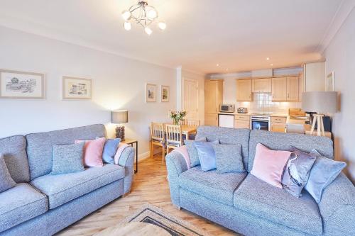 a living room with two couches and a kitchen at Host & Stay - Harbour View in Whitby