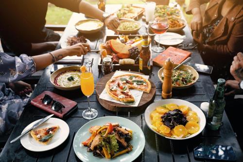 a group of people sitting around a table with plates of food at Hyatt Hyderabad Gachibowli in Hyderabad