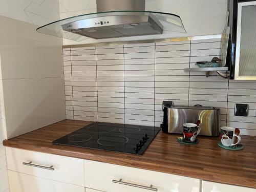 a kitchen with a stove and a microwave at Gite en Normandie in Rugles