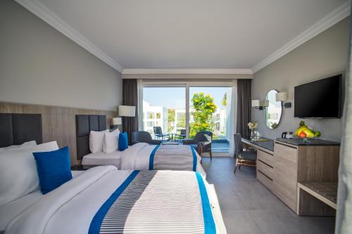 Cette chambre comprend deux lits et une télévision. dans l'établissement Maritim Jolie Ville Resort & Casino, à Charm el-Cheikh
