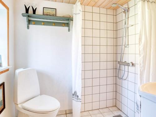 a bathroom with a toilet and a shower at Holiday home Læsø LIII in Læsø