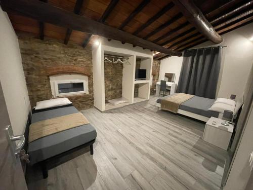 a bedroom with two beds and a fireplace at Rent room Iacopo in Capannori