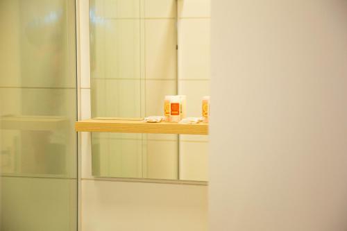a bathroom with a shower stall with a mirror at Pousada Águas de Maragogi in Maragogi