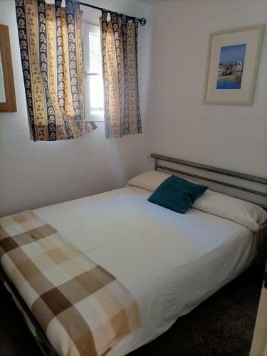 a bedroom with a bed and a window at Tottam Art & Healthy Garden in Málaga