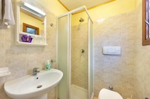 a bathroom with a sink and a shower at Villaggio Villa Lubrense in Massa Lubrense