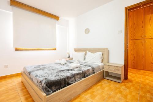 a bedroom with a large bed in a room at Napa Centrale Suites in Ayia Napa