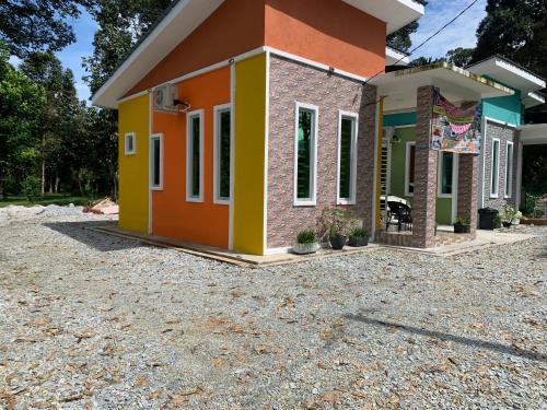 a small house with a colorful exterior at Damai Homestay in Kampong Jabi