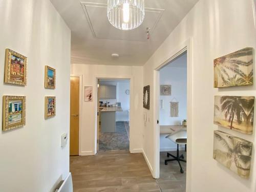 a hallway with a chandelier and a dining room at City Centre Apartment Northampton in Northampton