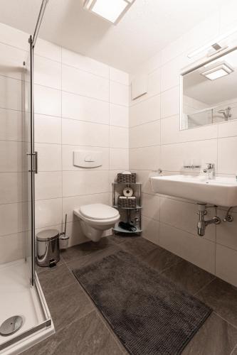 a white bathroom with a sink and a toilet at Appartement Natalie in Längenfeld
