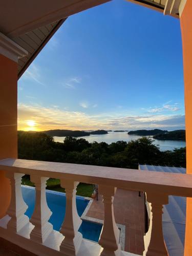 a view from the balcony of a house with the sunset at Boca Chica Bay Eco Lodge in Boca Chica