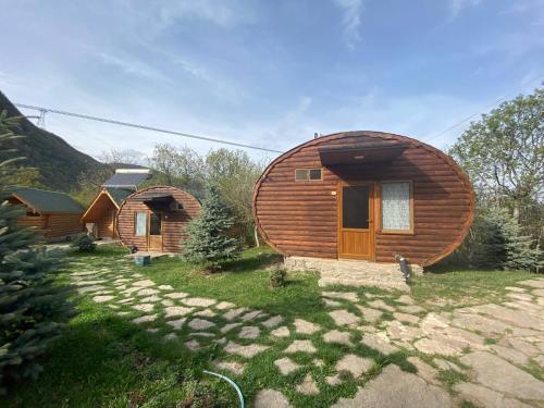 a group of wooden cabins in a yard with a path at Harsnadzor Eco Resort in Halidzor