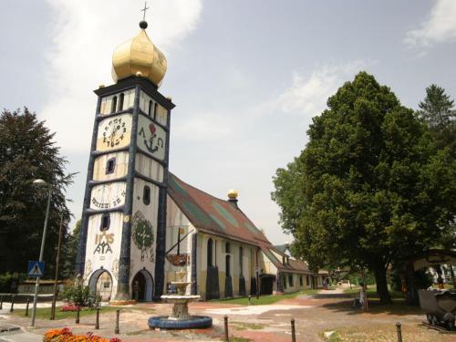 a clock tower in front of a building at Chalet in Carinthia with Sauna near Ski Slopes in Weinebene