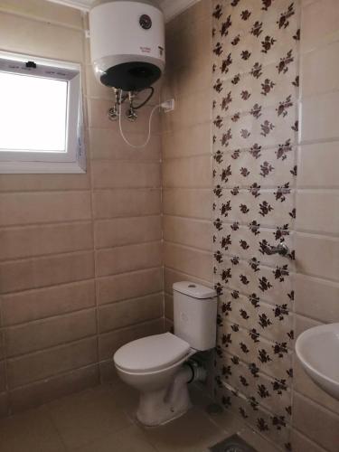 a bathroom with a toilet and a sink at 101 b in Hurghada