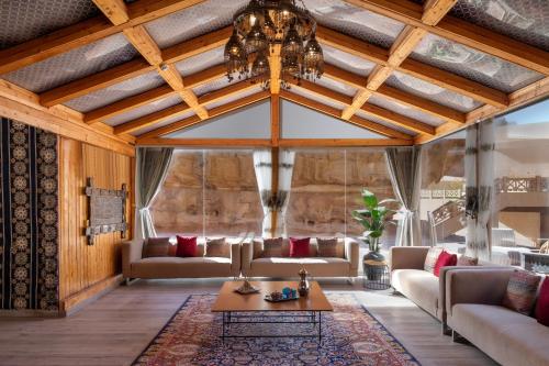 a living room with a couch and a chandelier at Shaden Resort in AlUla