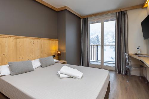 Postel nebo postele na pokoji v ubytování Hotel Piandineve