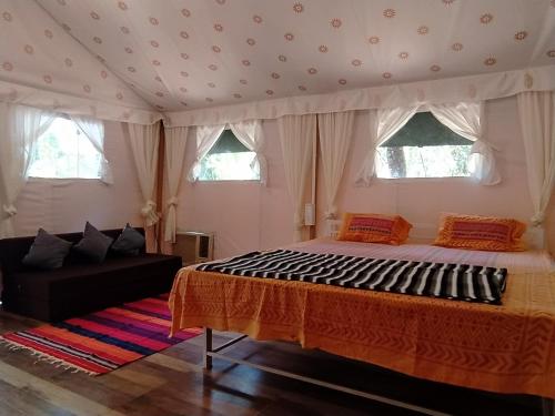 a bedroom with a bed and two windows at shree farm in Alibaug