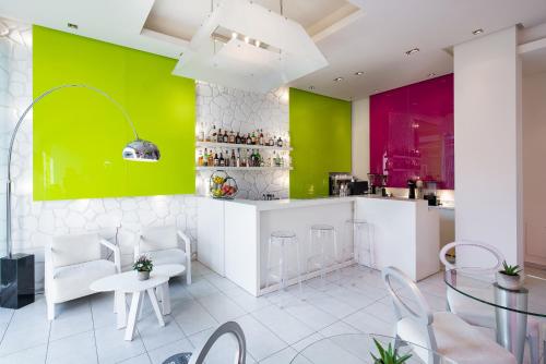 a kitchen with colorful walls and a table and chairs at Afrodite Suites in Potos