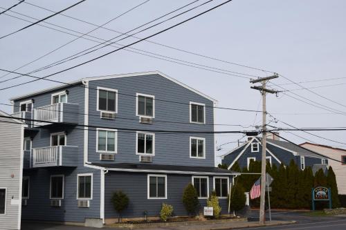 una casa azul al lado de una calle en Rhea's Inn by the Sea, en Middletown